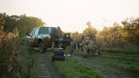 At sunlight soldier using laptop computer for surveillance during a military Stock Footage 241556709