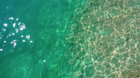 Sunlight sparkles over beautiful Amazing blue and green turquoise Stock Footage 328710180