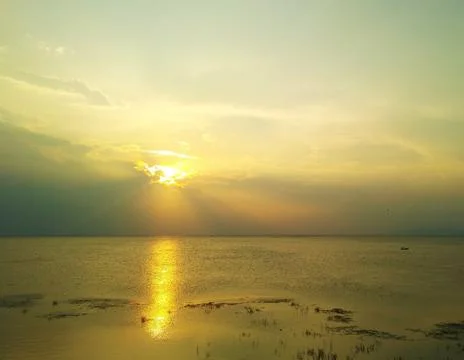 Sunlight spread over the lake in sunset Stock Photos