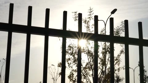 Sunlight Starburst Through Prison Bars - Symbol of Hope and Freedom 4K Video stock 327718448