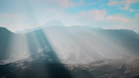 Sunlight streaming through clouds over mountains Stock Illustration