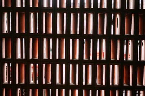 Sunlight streaming through a decorative terracotta wall pattern Stock Photos