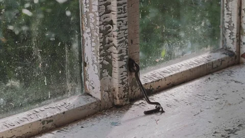 Sunlight streaming through a dirty window of an abandoned building Stock Footage 346315321