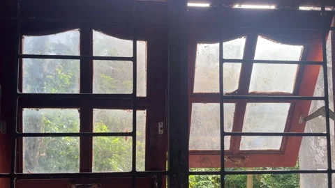 Sunlight streaming through dusty glass windows Video stock 328338840