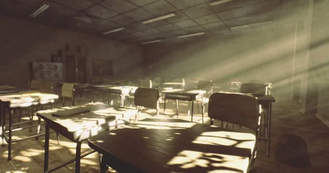 Sunlight streaming through an empty classroom with scattered desks and chairs Stock Footage 324713536