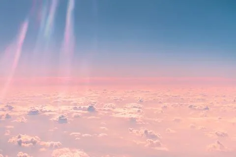 Sunlight streaming through fluffy clouds above creates a stunning interplay.. Stock Photos