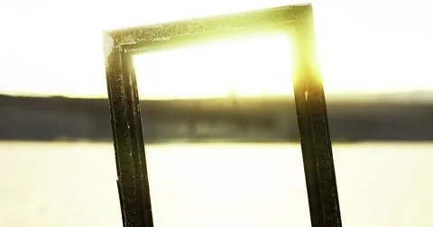 Sunlight streaming through a frame in a tranquil landscape at sunset Stock Illustration