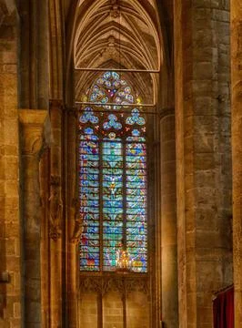 Sunlight streaming through a vibrant stained glass window casts colorful pa.. Stock Photos