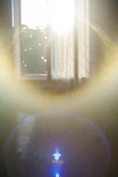 Sunlight streaming through window with lens flare Stock Photos