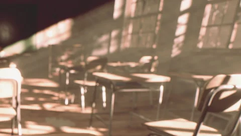 Sunlight Streams Into a Quiet, Empty Classroom 스톡 동영상 348111475
