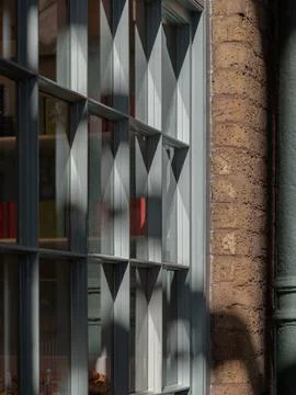 Sunlight streams through bakery shop glass window display. Stock Photos