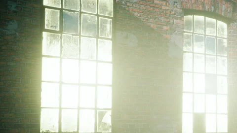 Sunlight streams through broken windows in an old brick building Stock Footage 343552952