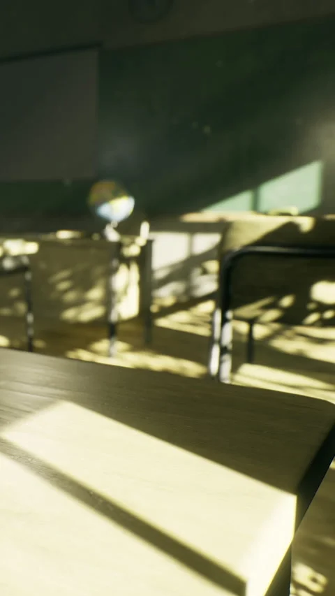 Sunlight streams through a classroom creating patterns on desks and chairs Stock Footage 335236930