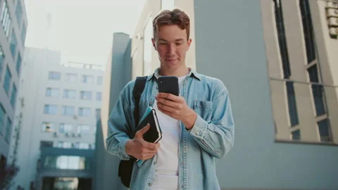 At sunlight student young handsome man with red hair stand near university or Stock Footage 142049735