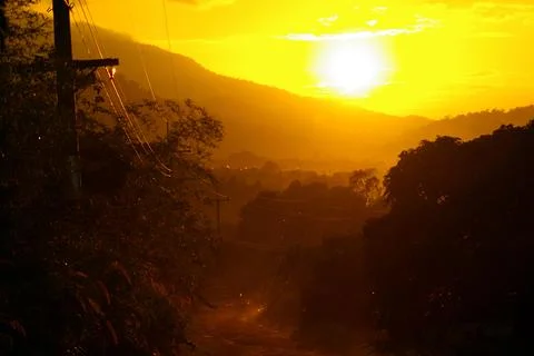 Sunlight of sunset and a dirt road in the countryside Stock Photos