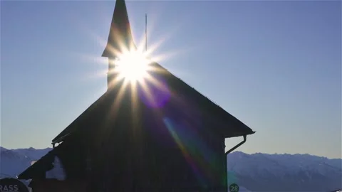 Sunlight Through Bell Tower of Small Wooden Church in Alps Mountain at Sunset Stock Footage 310809595