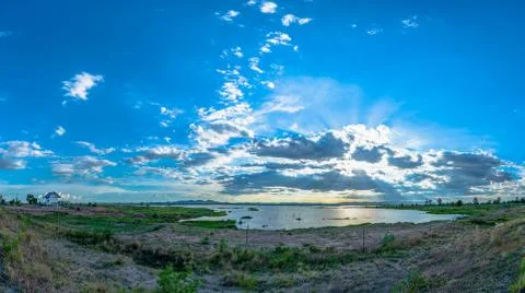 Sunlight through the cloud above the dam Stock Photos