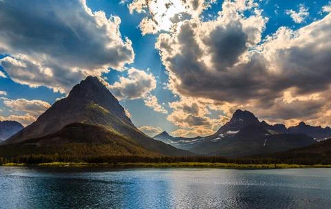 Sunlight through the Clouds on the Mountains over Swiftcurrent Lake, Many Stock Photos