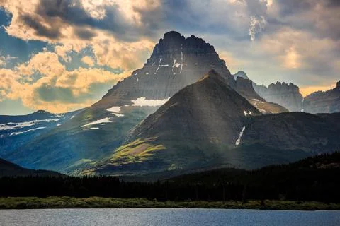 Sunlight through the Clouds on the Mountains over Swiftcurrent Lake, Many Stock Photos