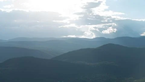 Sunlight Through Clouds on Mountains Stock Photos