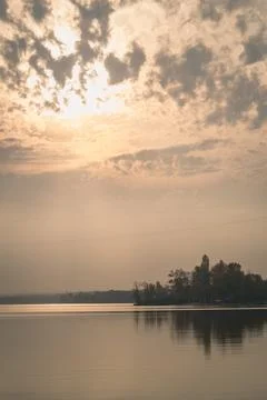 Sunlight through curly clouds above river landscape photo Stock-Fotos