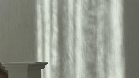 Sunlight Through Curtain Casts Moving Stripes on Wallpaper Stock Footage 348088475