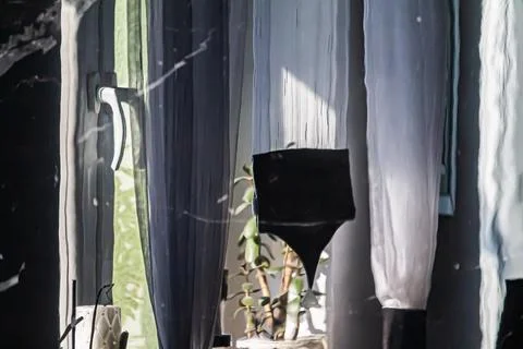 Sunlight through curtains in a cozy interior Stock Photos