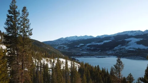 Sunlight through Pine Tree by Mountain Lake Stock Footage 119832525