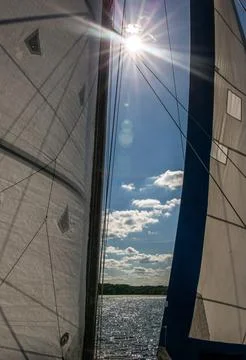Sunlight through the sails of a sailboat Stock Photos