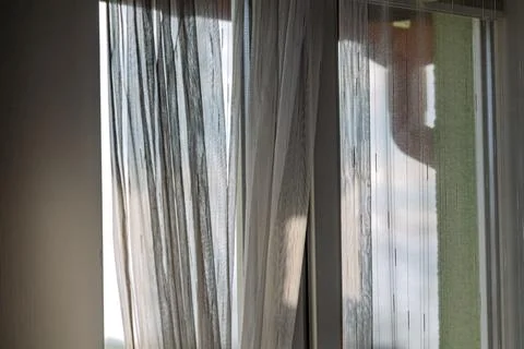 Sunlight through sheer curtains by window Stock Photos