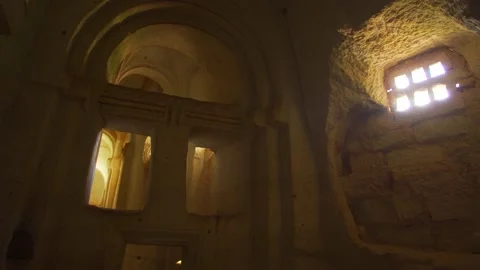 Sunlight through window holes inside of amazing ancient cave church Stock Footage 166397799