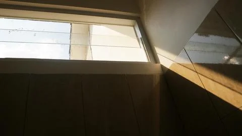 Sunlight through window on modern interior wall Stock Photos