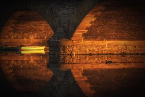 Sunlight under Workman Bridge in Evesham lighting up a on the River Avon 写真素材
