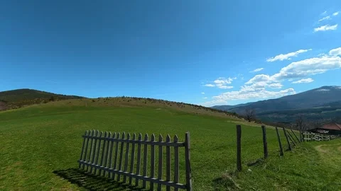 Sunlight warms a green hillside under vast blue sky. Balkan, Eastern Europe, POV Video stock 333442910