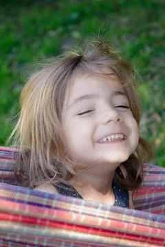 Sunlight warms her smiling face, eyes gently closed Stockfoto's