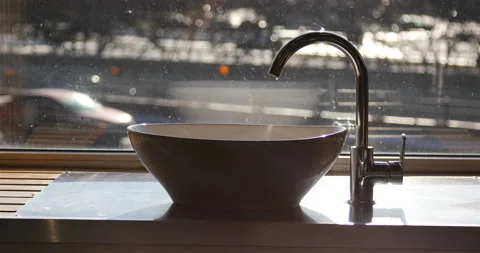 In the sunlight on the windowsill is a sink Stock Footage 139585260