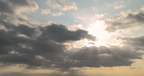 Sunlights and sun rays breaking through clumping clouds. timelapse. Stock Footage 252943340