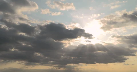 Sunlights and sun rays breaking through clumping clouds. Timelapse Stock Footage 252944889