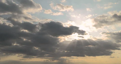 Sunlights and sun's rays breaking through clumping clouds. Timelapse. Stock Footage 252971333