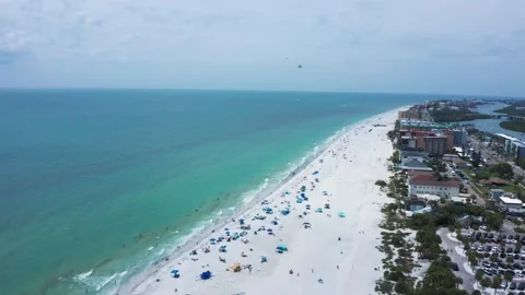 Sunlit Aerial View of Crowded Beach with Colorful Umbrellas 스톡 동영상 336704880