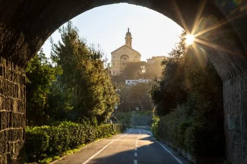 Sunlit arch over a bicycle path in Italy Stock Photos
