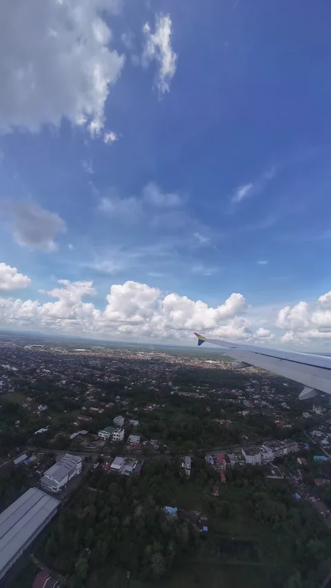 Sunlit Arrival: Smooth Landing on a Blue Sunny Day at Supadio Airport Stock Footage 276966384