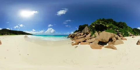 Sunlit beach with boulders and soft waves. La Digue, Seychelles. Stock Footage 343334865