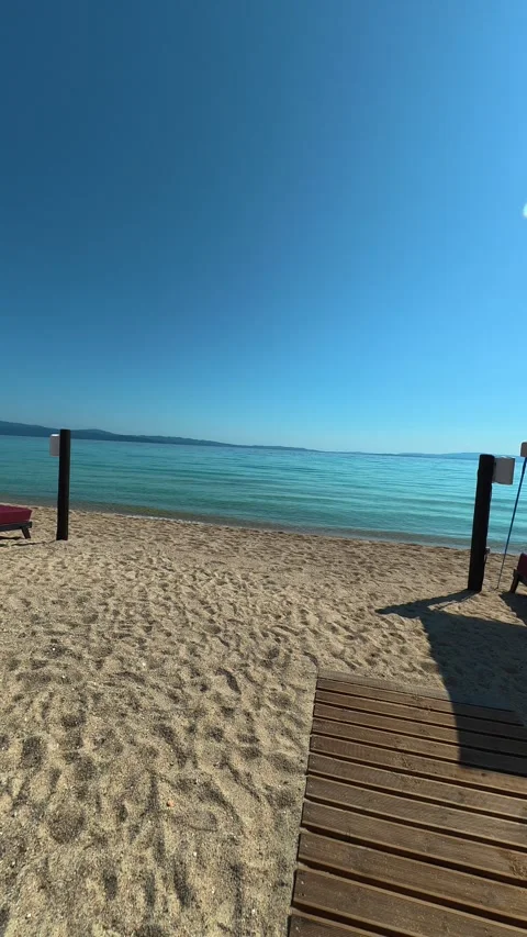 Sunlit beach with turquoise sea. Trani Ammouda, Greece. Vertical Stock Footage 339630448