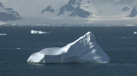 Sunlit berg, mountains behind, Antarctica Stock Footage 34313282