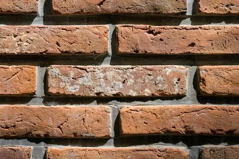 Sunlit bricks show worn, textured surfaces Stock Photos