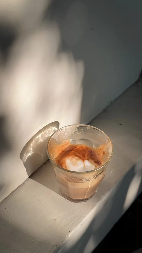 Sunlit Cappuccino on White Windowsill with Soft Moving Shadows Stock Footage 340594828