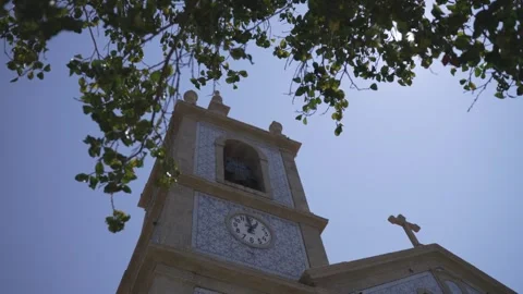 Sunlit church tower with clock and architectural detail Stock Footage 321517592