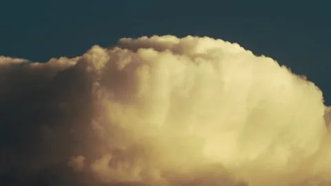 Sunlit Cloud Summit Against Deep Blue Evening Sky 動画素材 337527345