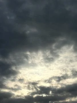 Sunlit Cloud Texture in Moody Gray Sky Stock Photos